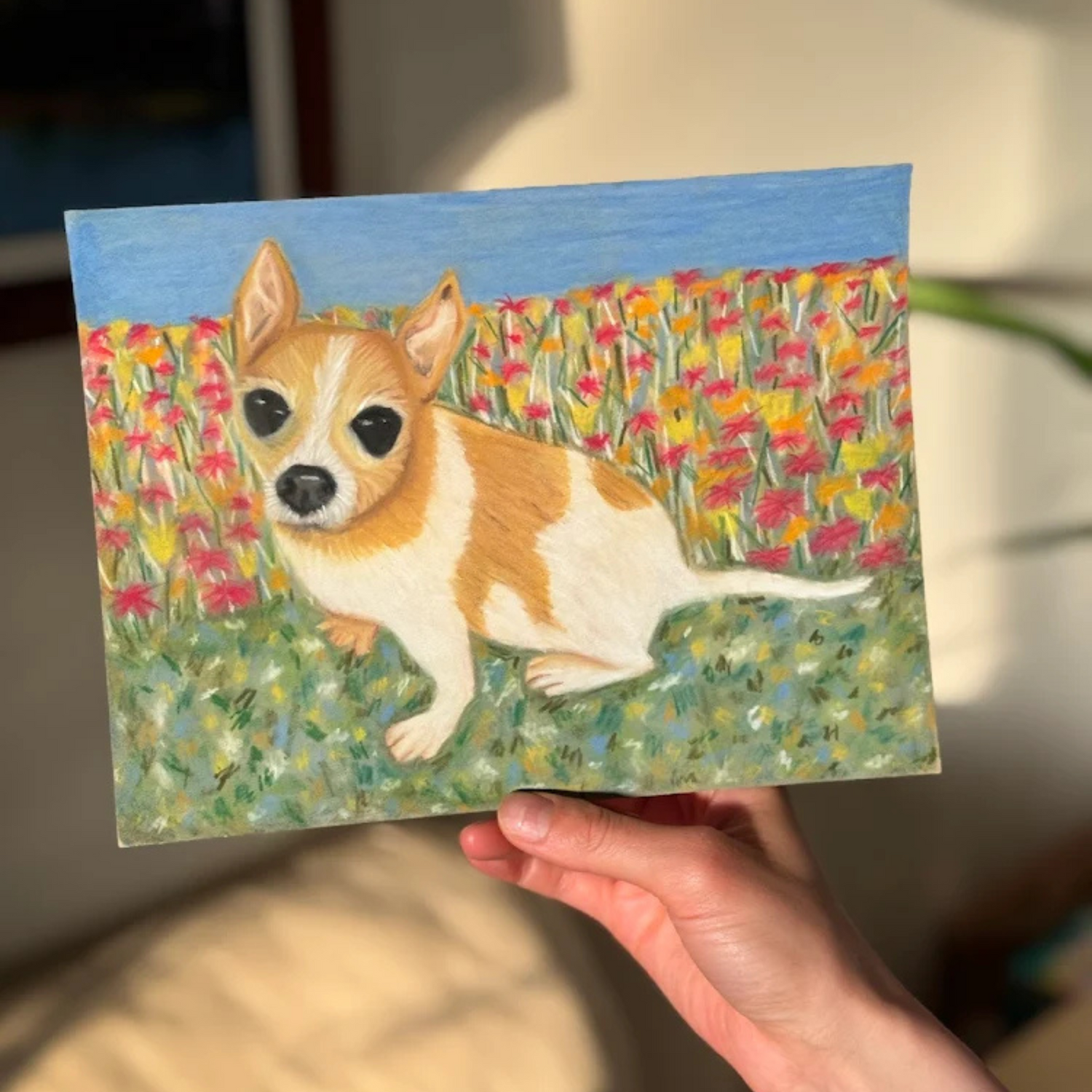 Client holding a custom memorial pastel portrait of their late Chihuahua, commissioned from Glasgow artist Hannah Kelly.